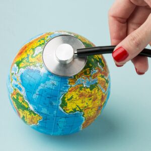 high-angle-hand-consulting-earth-with-stethoscope